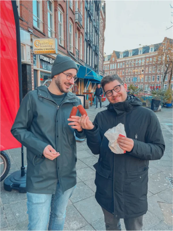 Two Colleagues eating sausage in Amsterdam